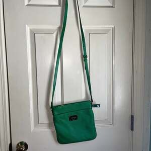 Lauren Ralph Lauren green leather purse.  It does have a lipstick stain inside.